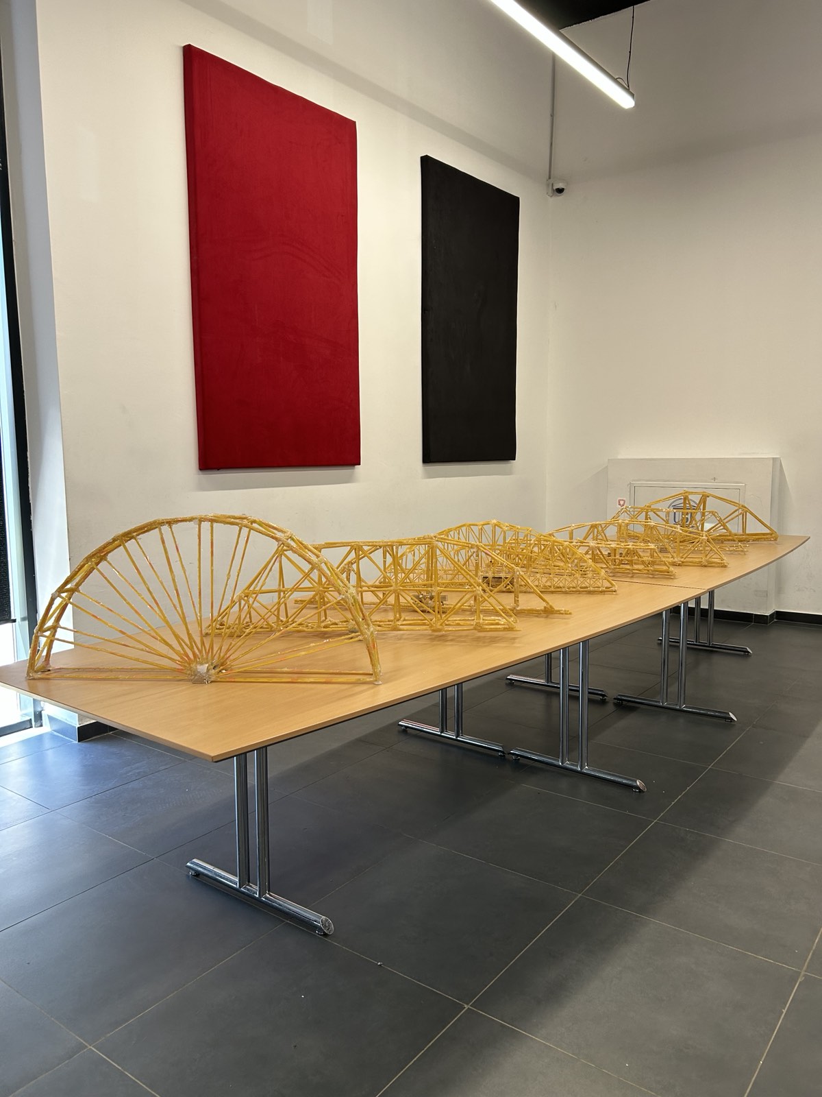 Spaghetti bridges produced by student teams lined up for the competition